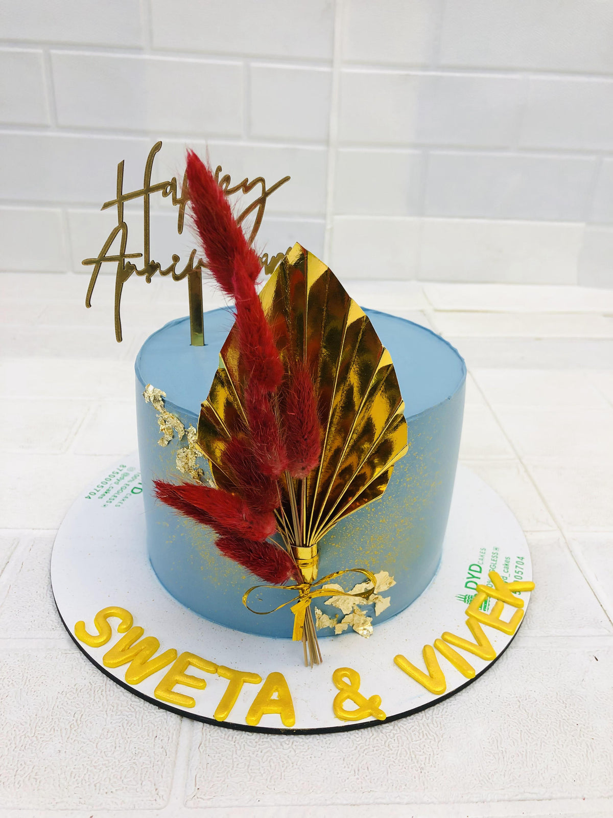 Blue Anniversary Cake With Golden Leave