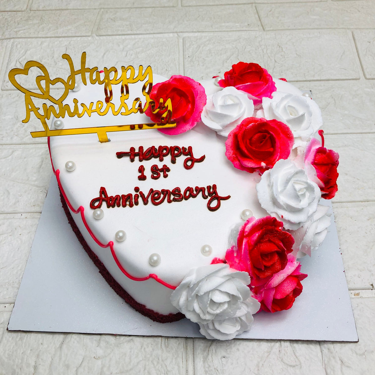 A beautifully crafted heart-shaped cake topped with elegant roses design, perfect for romantic occasions.